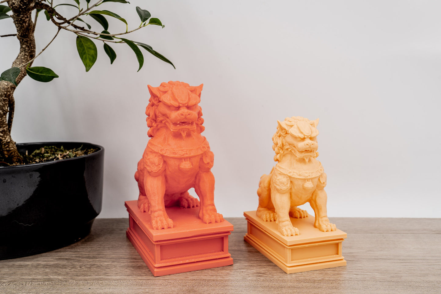 Salmon pink statue on left in large size, Orange color on right in Medium size